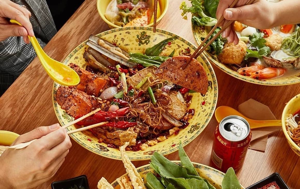 diners dig into a big bowl of hot pot at Dragon Hot Pot